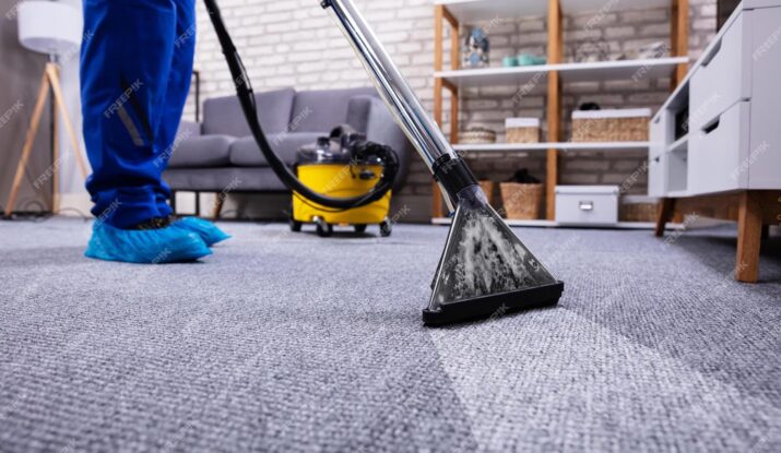 person-cleaning-carpet-with-vacuum-cleaner