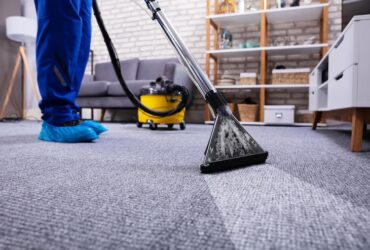 person-cleaning-carpet-with-vacuum-cleaner
