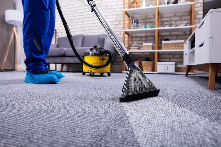 person-cleaning-carpet-with-vacuum-cleaner