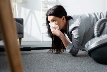 selective focus of allergic woman covering mouth with napkin