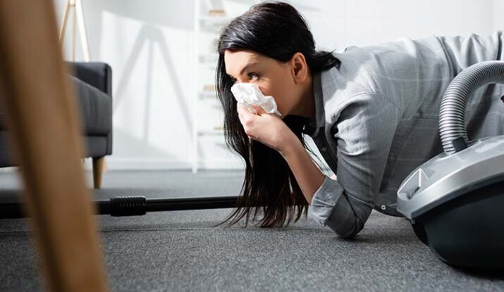 selective focus of allergic woman covering mouth with napkin